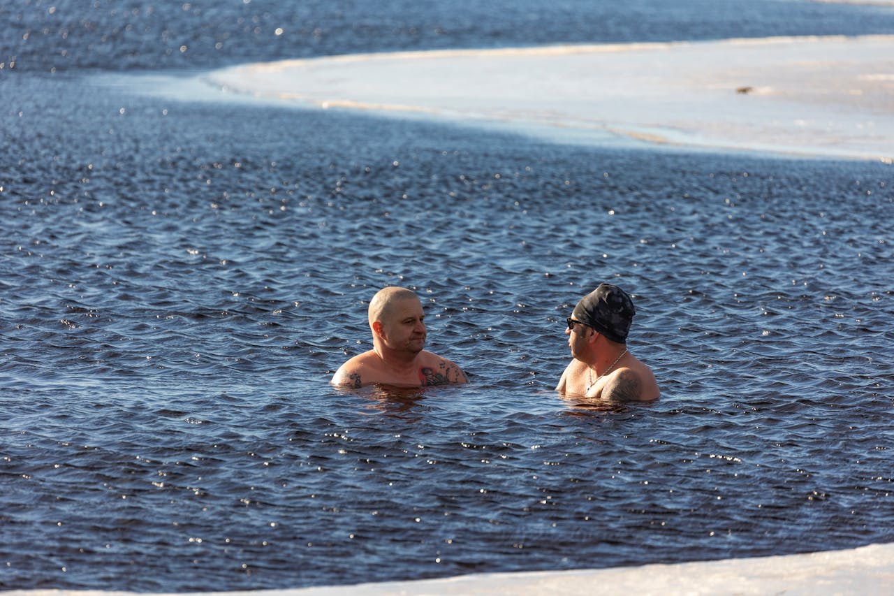 Two Men Swimming in a Sea in Winter. By Olavi Anttila
